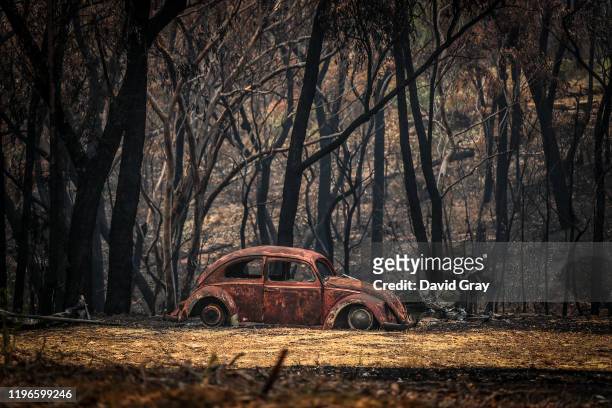 The remains of a car that was destroyed by bushfires sits near a home in the town of Balmoral on December 30, 2019 in Sydney, Australia. Firefighters...