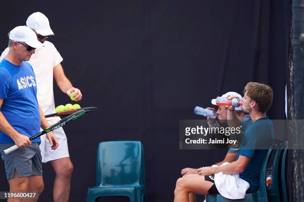 David Goffin and Steve Darcis of Belgium train on the practice courts with his team on December 30, 2019 in Sydney, Australia.