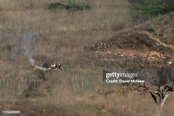 Investigators work at the scene of a helicopter crash that killed former NBA star Kobe Bryant on January 26, 2020 in Calabasas, California. Nine...