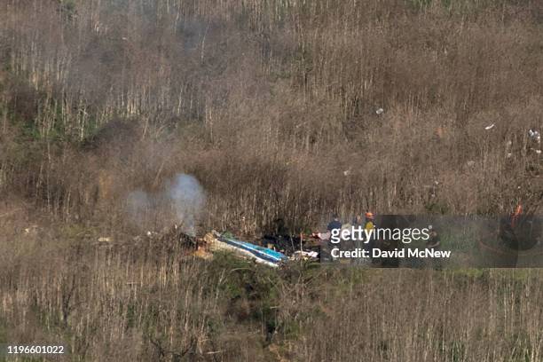 Investigators work at the scene of a helicopter crash that killed former NBA star Kobe Bryant on January 26, 2020 in Calabasas, California. Nine...