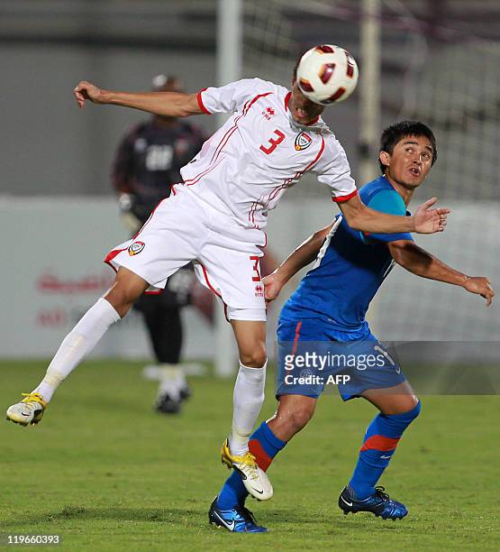 India's Jeje Lalpekhlua challenges UAE's Walid Abbas as he heads the ball during their 2014 World Cup Asian zone qualifying football match in Al-Ain...