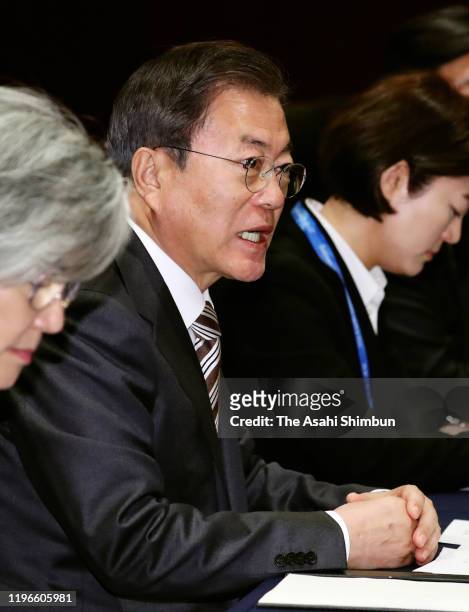 South Korean President Moon Jae-in talks to Japanese Prime Minister Shinzo Abe during their bilateral meeting on the sidelines of the South...
