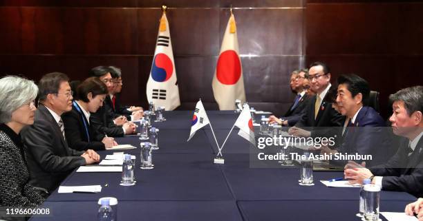 South Korean President Moon Jae-in and Japanese Prime Minister Shinzo Abe talk during their bilateral meeting on the sidelines of the South...