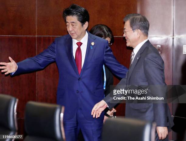South Korean President Moon Jae-in is escorted by Japanese Prime Minister Shinzo Abe prior to their bilateral meeting on the sidelines of the South...