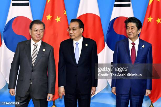South Korean President Moon Jae-in, Chinese Premier Li Keqiang and Japanese Prime Minister Shinzo Abe pose for the family photos prior to the South...