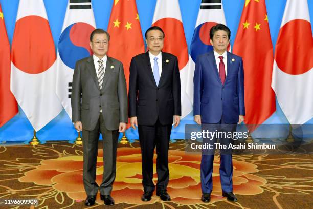 South Korean President Moon Jae-in, Chinese Premier Li Keqiang and Japanese Prime Minister Shinzo Abe pose for the family photos prior to the South...