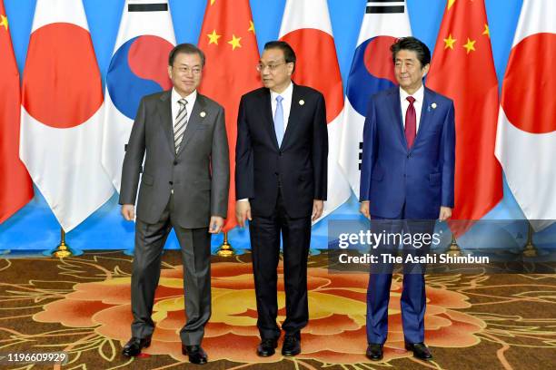 South Korean President Moon Jae-in, Chinese Premier Li Keqiang and Japanese Prime Minister Shinzo Abe pose for the family photos prior to the South...