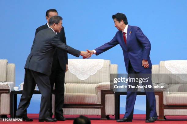 South Korean President Moon Jae-in, Chinese Premier Li Keqiang and Japanese Prime Minister Shinzo Abe attend the South Korea-Japan-China Business...