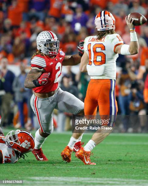 Defensive end Chase Young of the Ohio State Buckeyes pressures quarterback Trevor Lawrence of the Clemson Tigers during the second half of the...