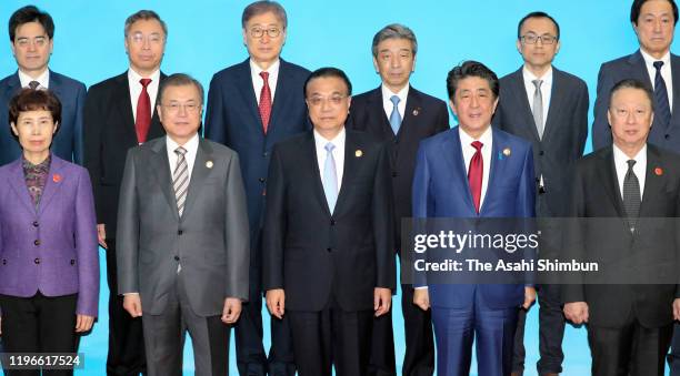 South Korean President Moon Jae-in, Chinese Premier Li Keqiang and Japanese Prime Minister Shinzo Abe pose during the South Korea-Japan-China...