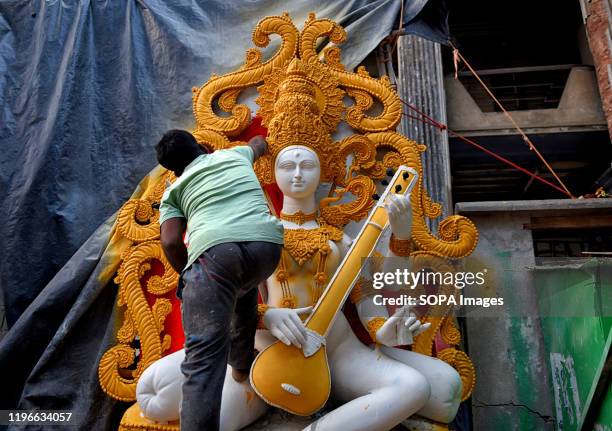 An artist making final touches to an Idol of Hindu Goddess Saraswati during the preparations for the festival. Basant Panchami or Vasant Panchami is...