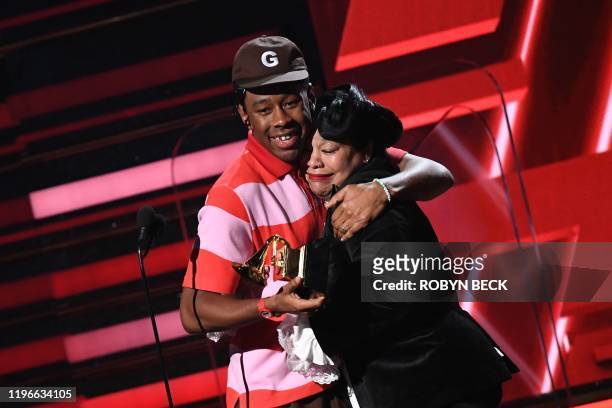 Rapper Tyler, the Creator accepts the award for Best Rap Album alongside his mom during the 62nd Annual Grammy Awards on January 26 in Los Angeles.