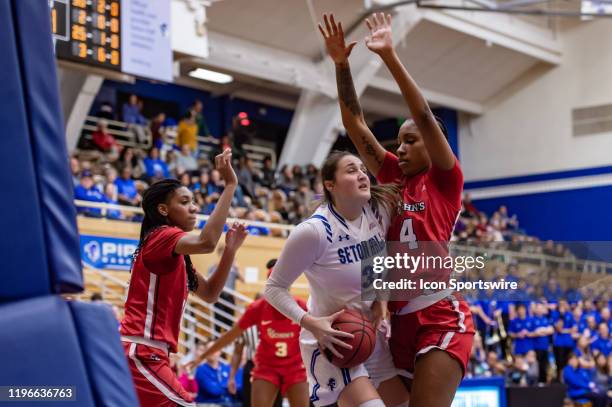 Seton Hall Pirates forward Alexia Allesch is closely defended by St. John's Red Storm forward Raven Farley during the first half of the womens...