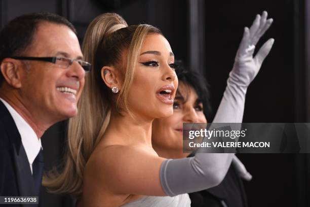 Singer-songwriter Ariana Grande arrives with her parents Joan Grande and Edward Butera for the 62nd Annual Grammy Awards on January 26 in Los Angeles.