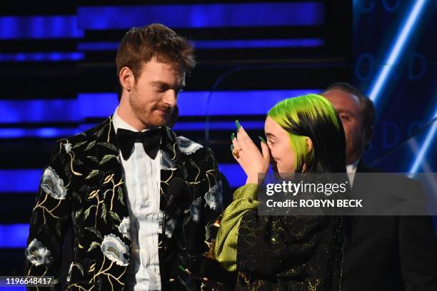 Singer-songwriter Billie Eilish and US producer Finneas accept the award for Record Of The Year for "Bad Guy" during the 62nd Annual Grammy Awards on...