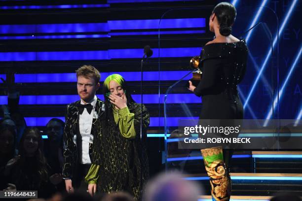 Singer-songwriter Billie Eilish and US producer Finneas accept the award for Record Of The Year for "Bad Guy" during the 62nd Annual Grammy Awards on...