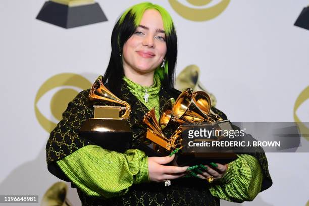 Singer-songwriter Billie Eilish poses in the press room with the awards for Album Of The Year, Record Of The Year, Best New Artist, Song Of The Year...