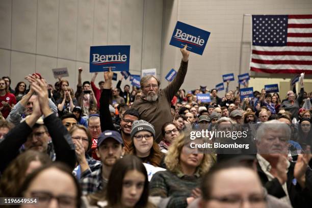 Attendees hold signs as Senator Bernie Sanders, an Independent from Vermont and 2020 presidential candidate, not pictured, speaks during a campaign...