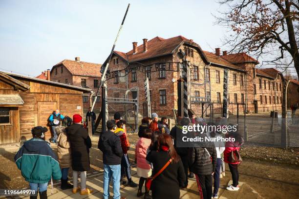 Visitors in front of 'Arbeit macht frei' entrance gate at the former Nazi German Auschwitz I concentration and extermination camp in Oswiecim, Poland...