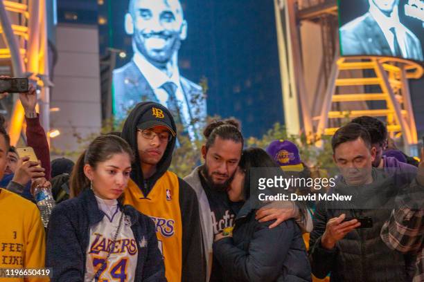 People mourn for former NBA star Kobe Bryant, who was killed in a helicopter crash in Calabasas, California, near Staples Center on January 26, 2020...