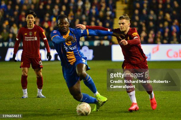 Shrewsbury Town's Aaron Pierre vies for possession with Harvey Elliott of Liverpool during the FA Cup Fourth Round match between Shrewsbury Town and...