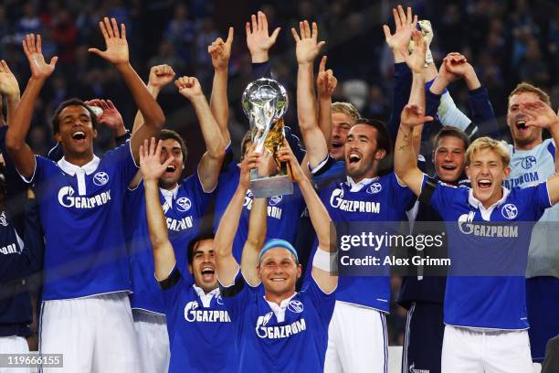 Players of Schalke celebrate after winning the Supercup match against Borussia Dortmund at Veltins Arena on July 23, 2011 in Gelsenkirchen, Germany.