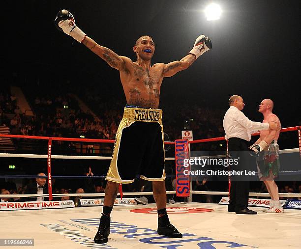 Ashley Theophane celebrates as he knocks out Jason Cook during the British Light welterweight Title fight at Wembley Arena on July 23, 2011 in...