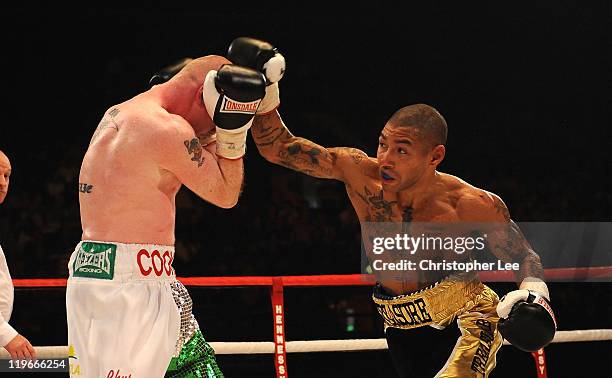 Ashley Theophane throws a punch at Jason Cook during the British Light welterweight Title fight at Wembley Arena on July 23, 2011 in London, England.