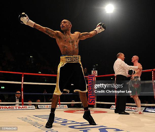 Ashley Theophane celebrates as he knocks out Jason Cook during the British Light welterweight Title fight at Wembley Arena on July 23, 2011 in...