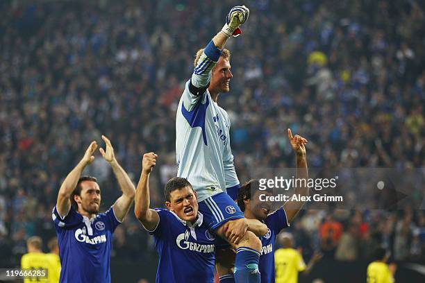 Goalkeeper Ralf Faehrmann of Schalke celebrates with team mates Christian Fuchs, Kyriakos Papadopoulos and Raul after winning the Supercup match...