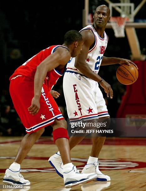 All-Star Michael Jordan of the Washington Wizards dribbles around Kobe Bryant of the Los Angeles Lakers 09 February, 2003 during the NBA All-Star...