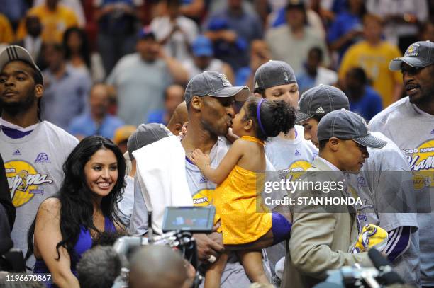 Kobe Bryant of the Los Angeles Lakers celebrates victory with his family following Game 5 of the NBA Finals against the Orlando Magic at Amway Arena...