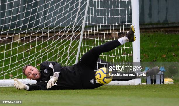 Goalkeeper Rob Elliot dives to make a save during the Newcastle United Training session at the Newcastle United Training Centre on December 30, 2019...