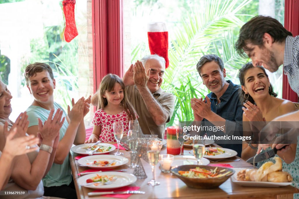Family having a christmas eve lunch with a traditional matambre meat