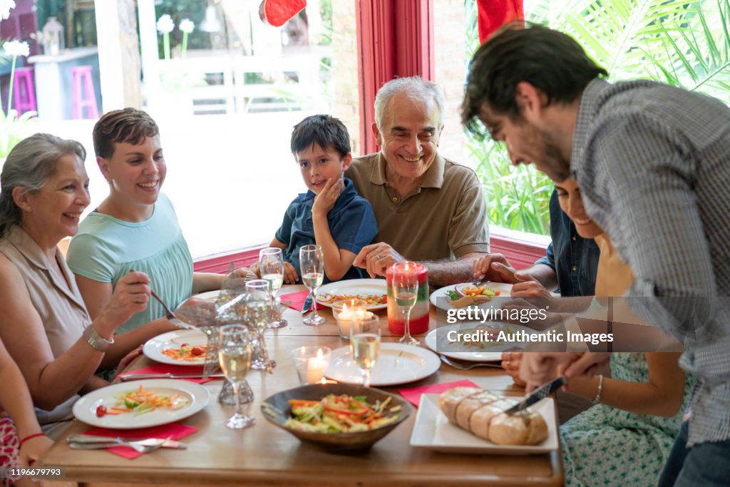 Family having a christmas eve lunch with a traditional matambre meat