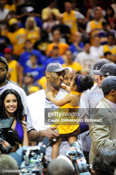 Kobe Bryant of the Los Angeles Lakers celebrates with his family at the end of Game 5 in the NBA Finals against the Orlando Magic at Amway Arena on...