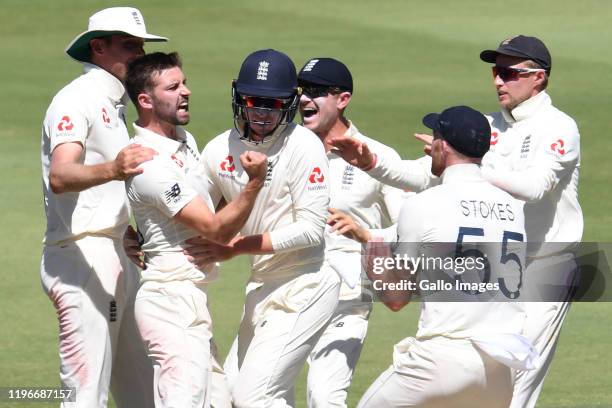 Mark Wood and Ollie Pope of England celebrates the wicket of Rassie van der Dussen of the Proteas during day 4 of the 4th Test match between South...