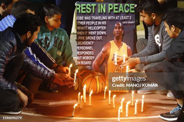 Gurgaon Basketball players light candles as they pay tribute to American professional basketball player Kobe Bryant in Gurgaon on January 27, 2020. -...