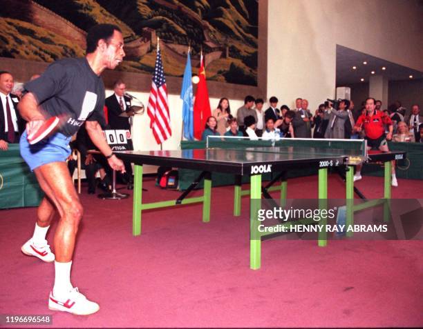 American George Brathwaite returns a shot to China's Liang Geliang 24 July at the United Nations in New York during an exhibition match celebrating...