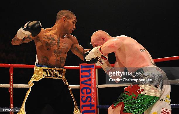 Ashley Theophane throws a punch at Jason Cook during the British Light welterweight Title fight at Wembley Arena on July 23, 2011 in London, England.