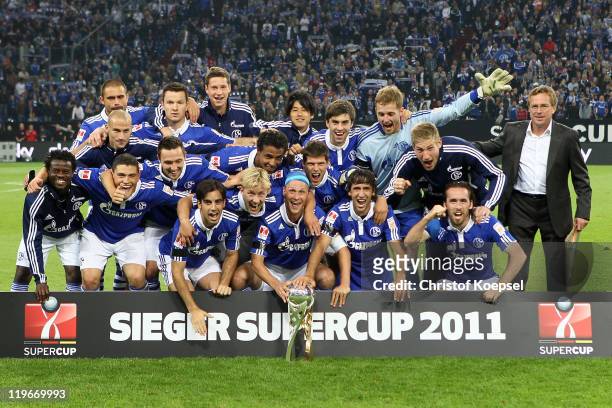The team of Schalke poses with the Supercupo trophy after winning the Supercup match between FC Schalke 04 and Borussia Dortmund at Veltins Arena on...