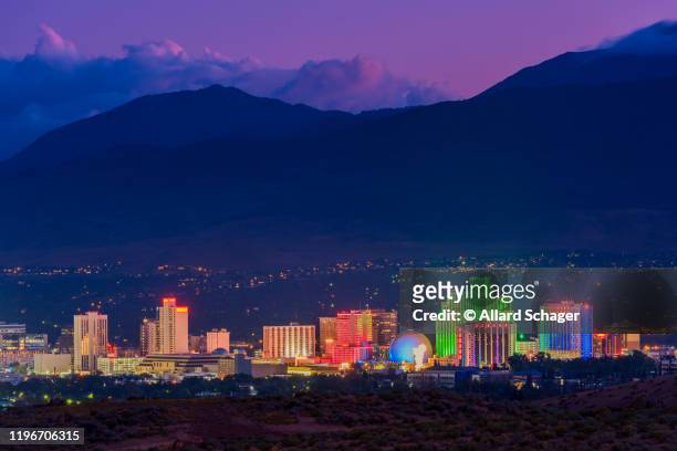 skyline of reno nevada at dusk - nevada stock pictures, royalty-free photos & images
