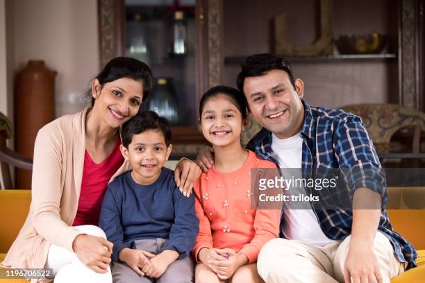 happy indian family at home - india stock pictures, royalty-free photos & images