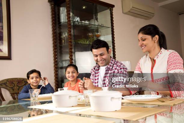 family having lunch at home - indian family dinner table stock pictures, royalty-free photos & images