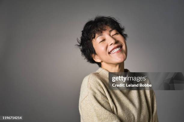 studio portrait of middle aged japanese woman - eyes closed smile stock pictures, royalty-free photos & images