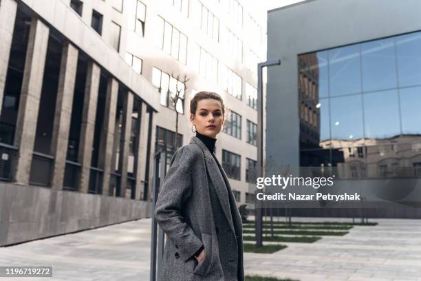 fashion editorial style pictures of a beautiful girl exploring the raw spaces of a city - city map stockfoto's en -beelden