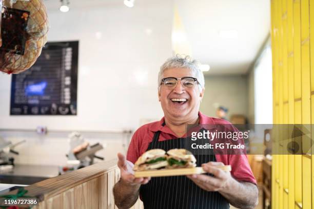 waiter holding a dish - sandwich shop stock pictures, royalty-free photos & images