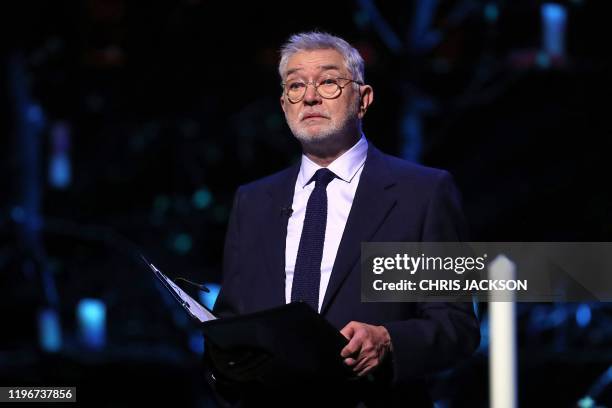 British actor Martin Shaw reads during the UK Holocaust Memorial Day Commemorative Ceremony at Methodist Central Hall in London on January 27, 2020....