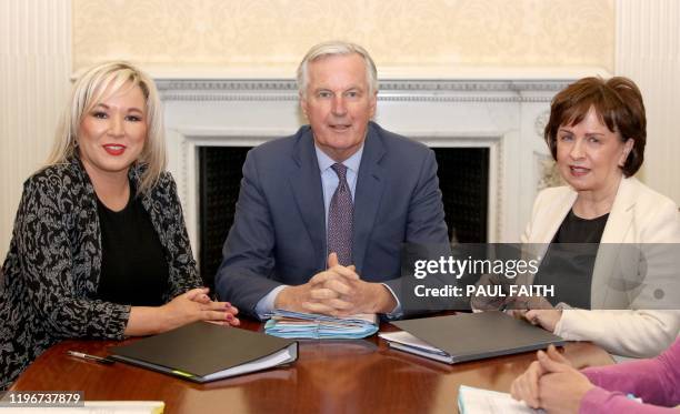 Northern Ireland's Deputy First Minister Michelle O'Neill and Ecomony Minister Diane Dodds pose for a photo with the EU's chief Brexit negotiator...