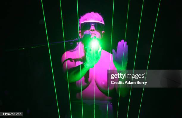 Canadian musician, producer, and performance artist Peaches performs on a laser harp during her show "Peaches: There's Only One Peach With The Hole...